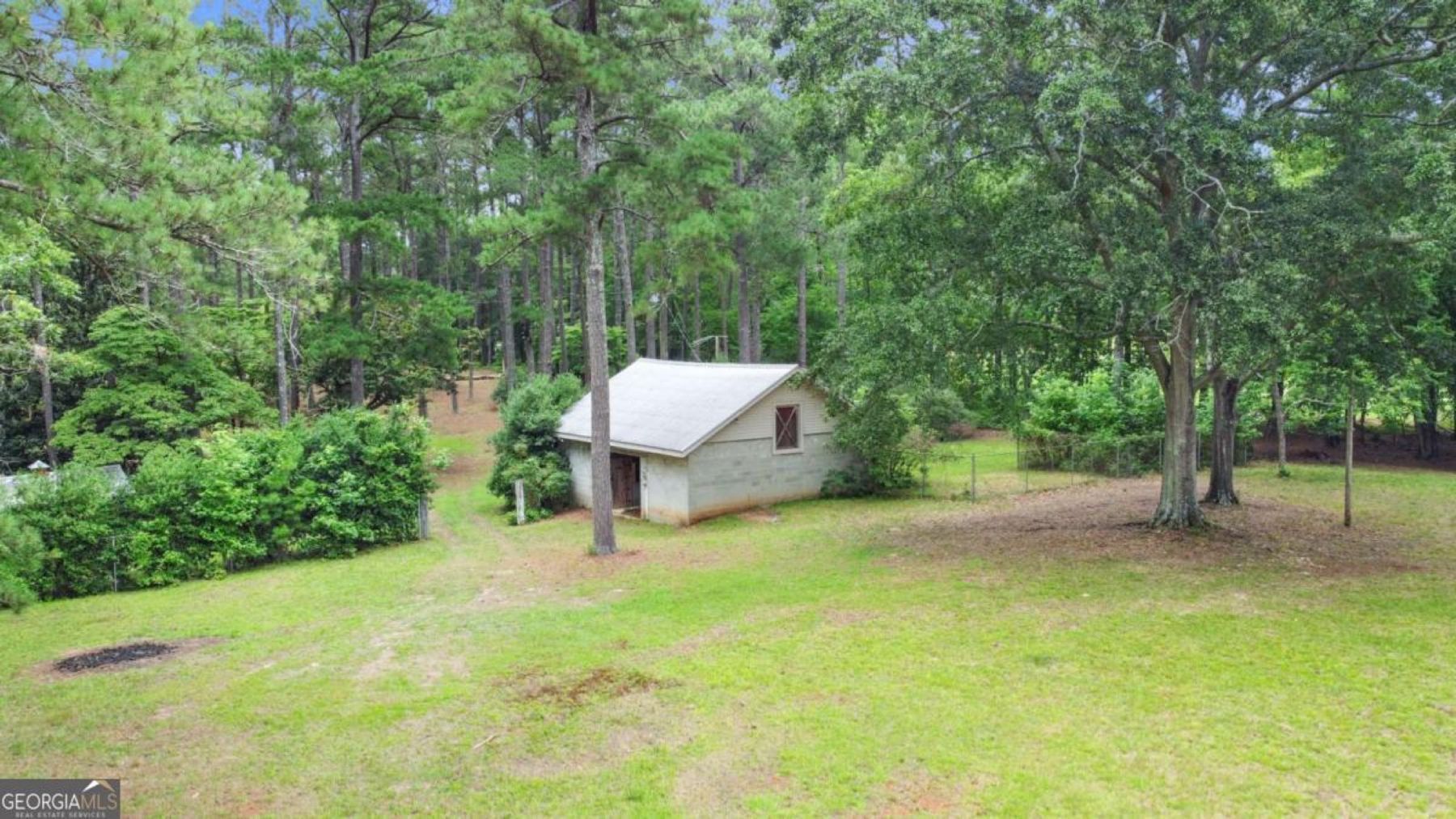 Horse barn and outbuilding among mature trees, 0 Hutcheson Ferry Rd, Chattahoochee Hills, GA