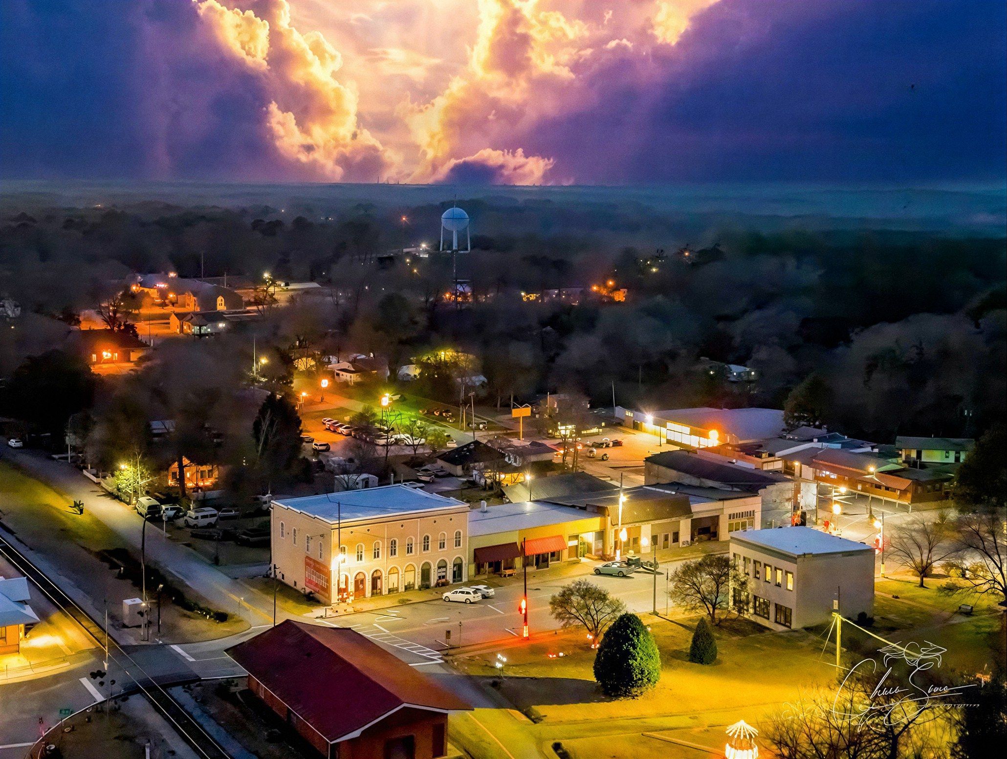 Downtown Grantville, GA lit up at dusk with the water tower beyond